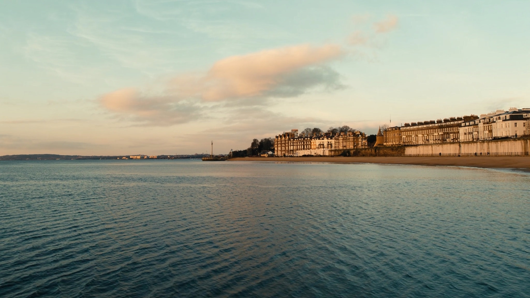 Portsmouth harbour at dusk with boats and waterfront buildings